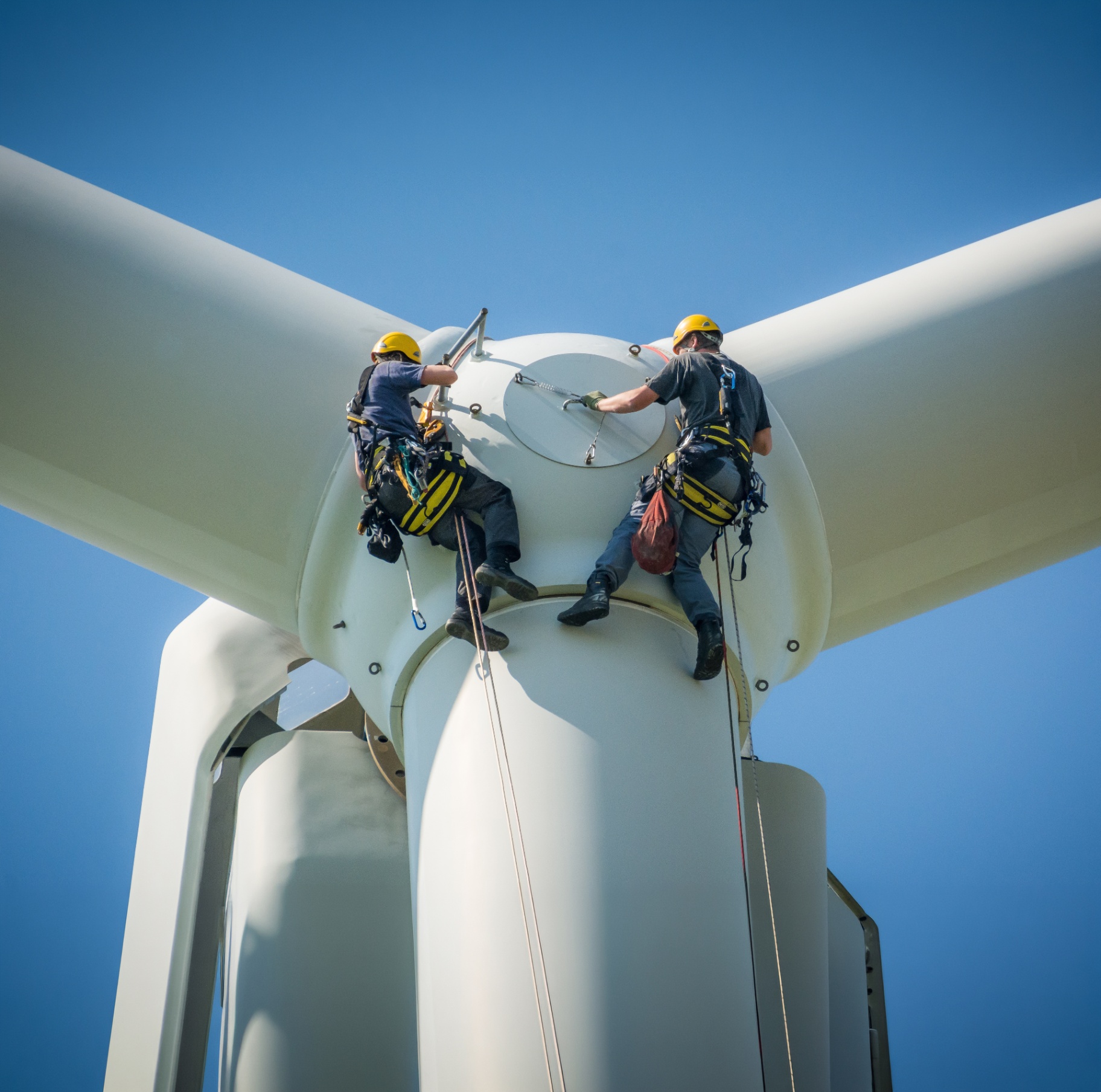 Wind turbine technicians performing maintenance at hub height